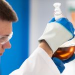 a chemist examining chemicals in a flask